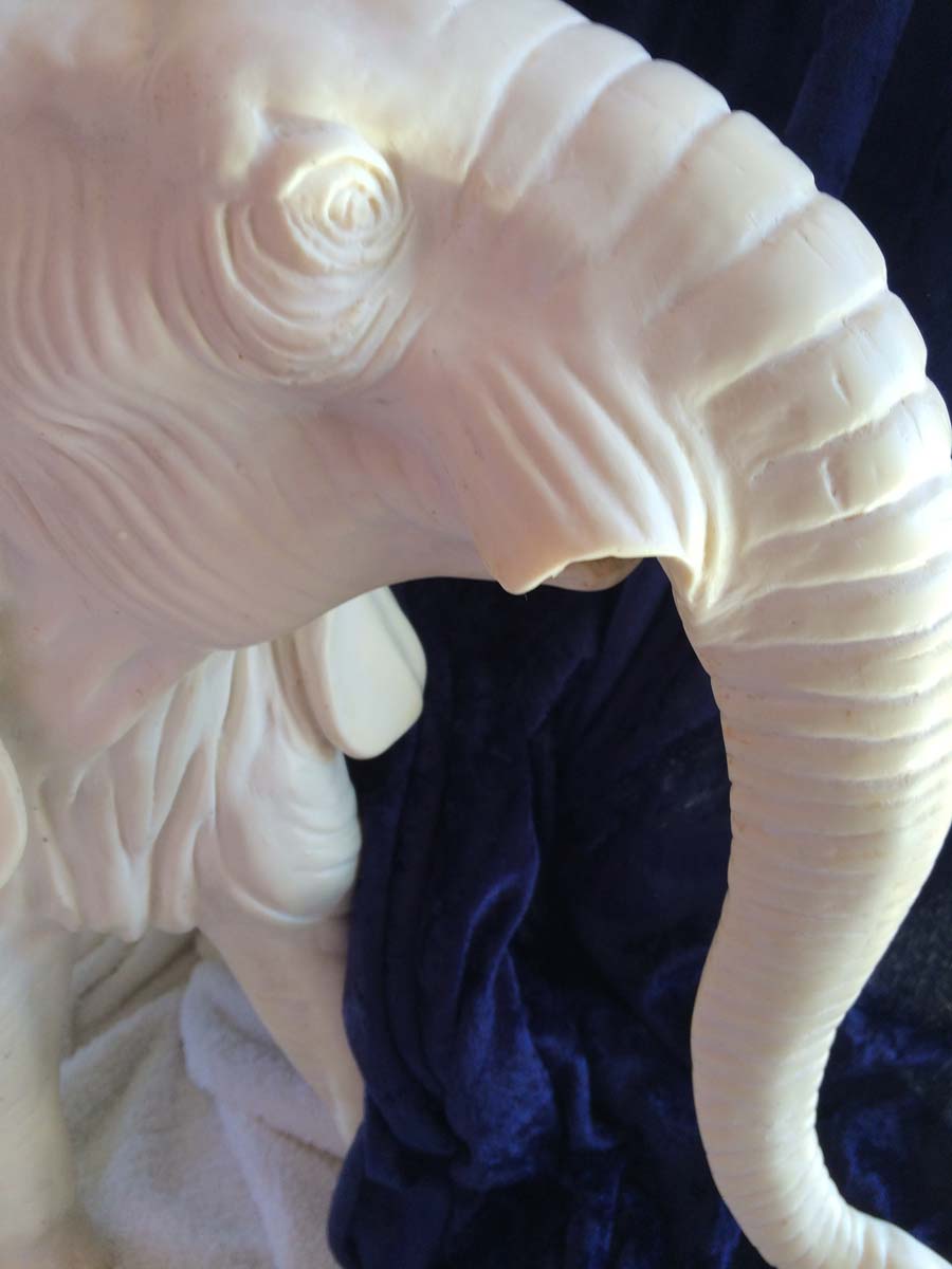 broken tusk on alabaster elephant